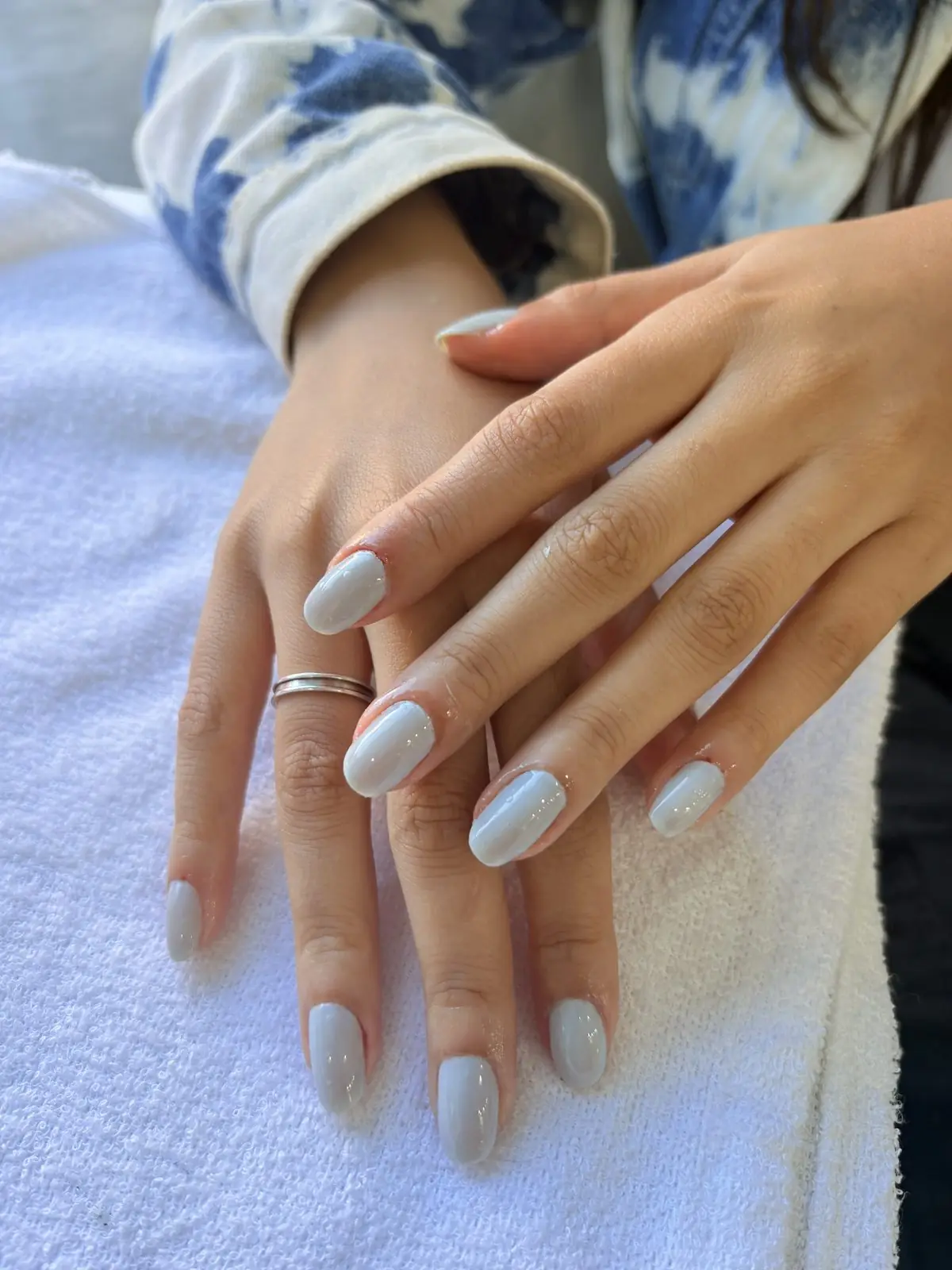 Mãos com esmalte claro após manicure
